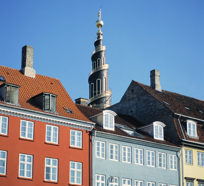 The spiral tower of the Church of Our Saviour above colourful buildings in Christianshavn.