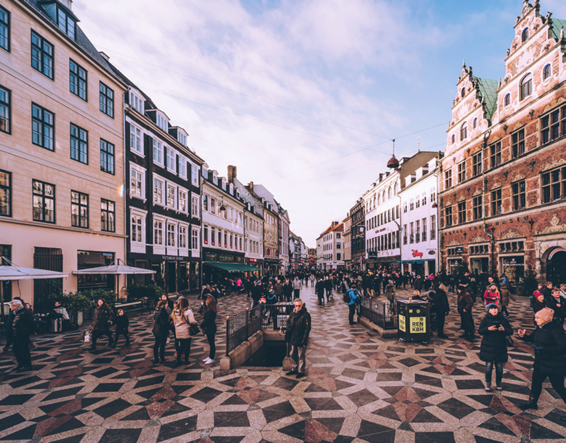 Crowded square on Strøget, Copenhagen, showing people shopping, walking, and enjoying the city’s central pedestrian area.