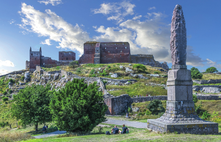 Ruins of Hammershus Castle on Bornholm surrounded by green landscape.