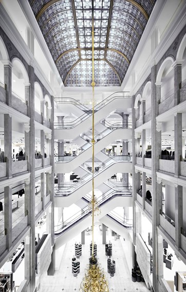Interior view of ILLUM department store in Copenhagen, showing multiple floors and luxury displays.