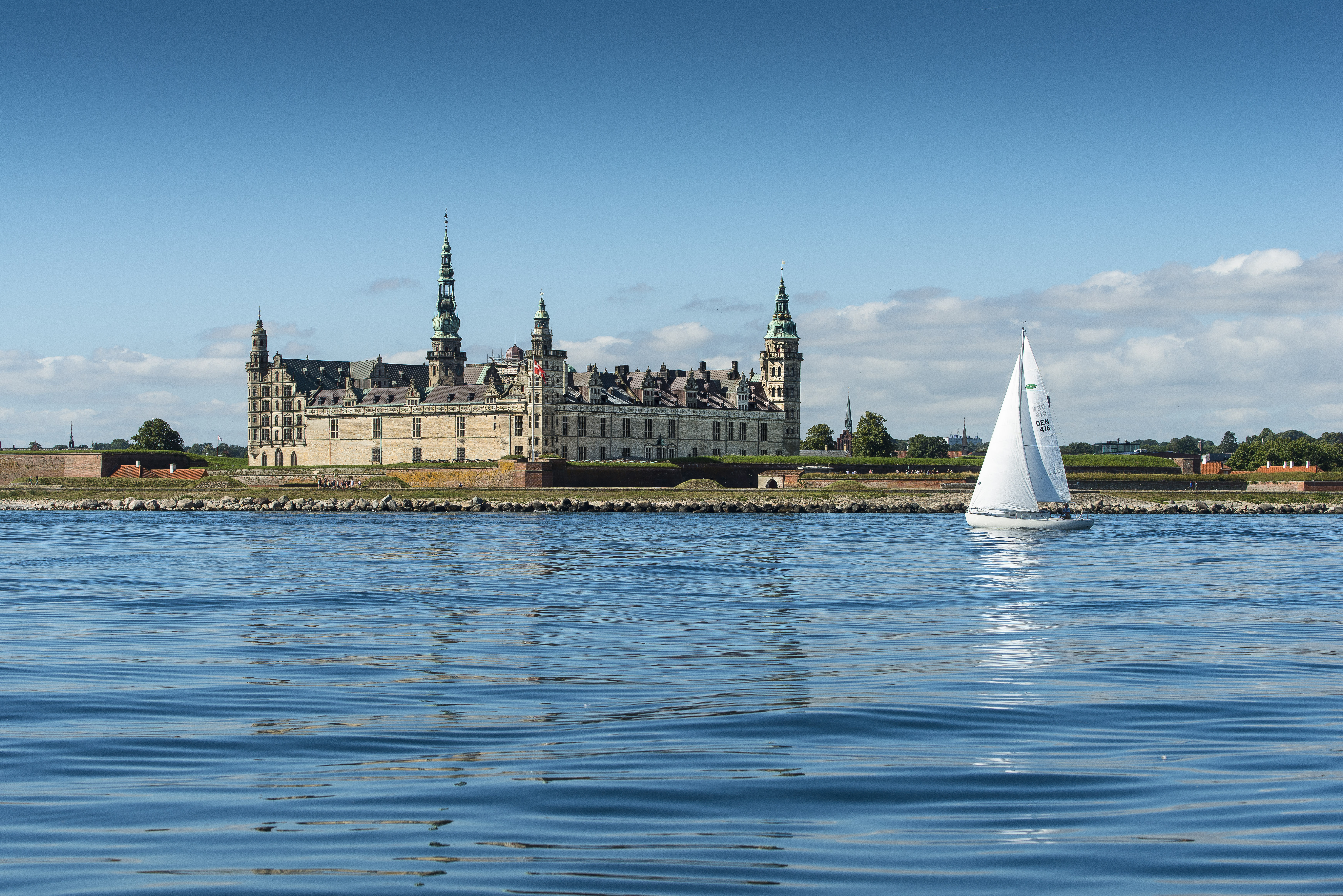 Kronborg Castle in Helsingør reflected in calm water.